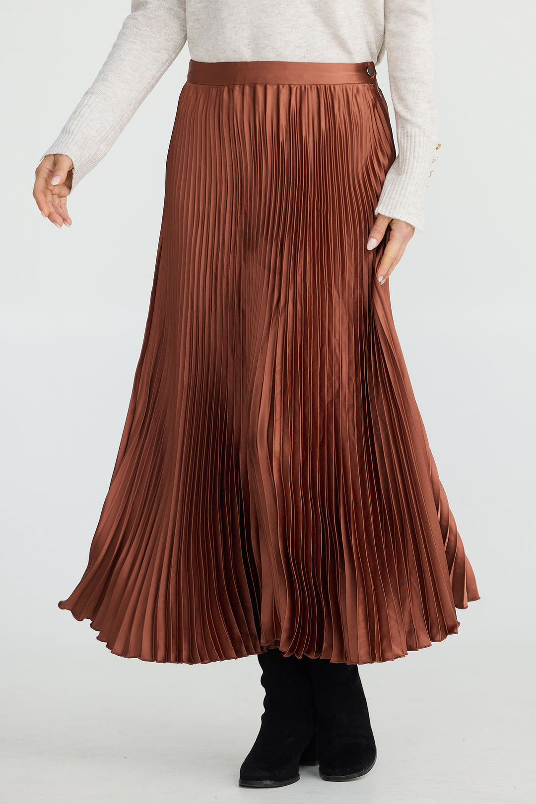 Brown pleated skirt worn by a person on a white background