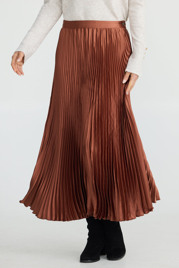 Brown pleated skirt worn by a person on a white background