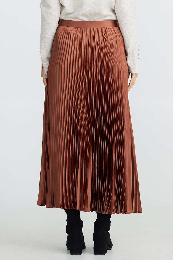Person wearing a brown pleated skirt on a white background