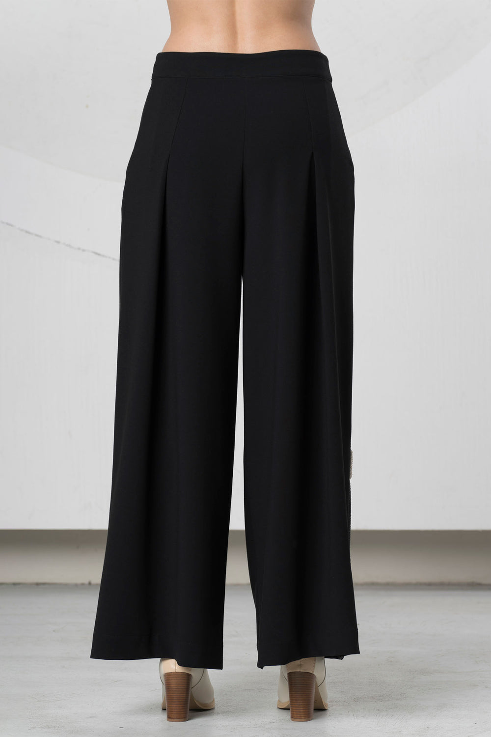 Black wide-leg pants on a neutral background