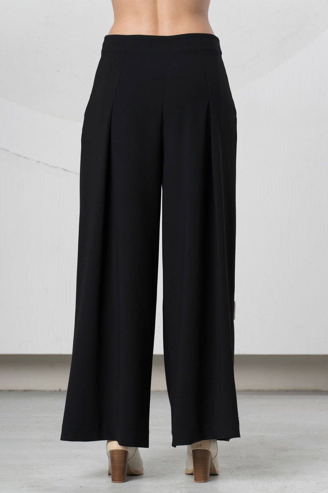 Black wide-leg pants on a neutral background