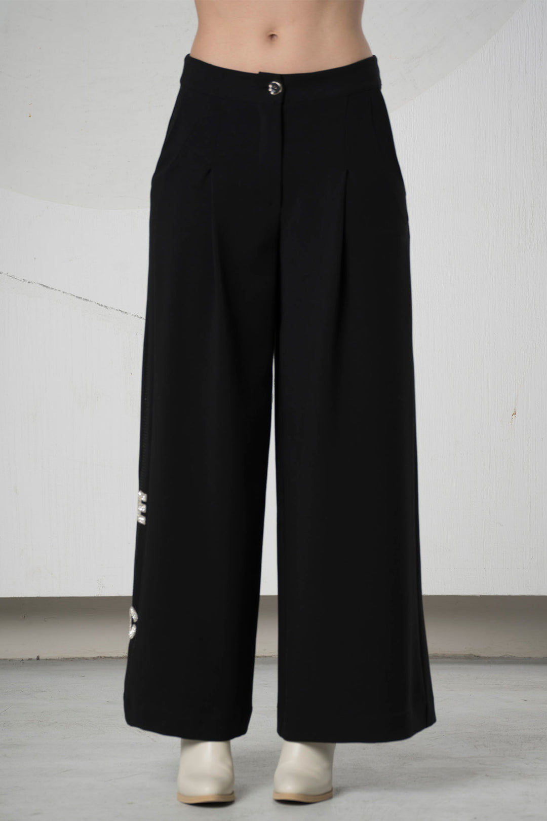 Black wide-leg pants on a plain background