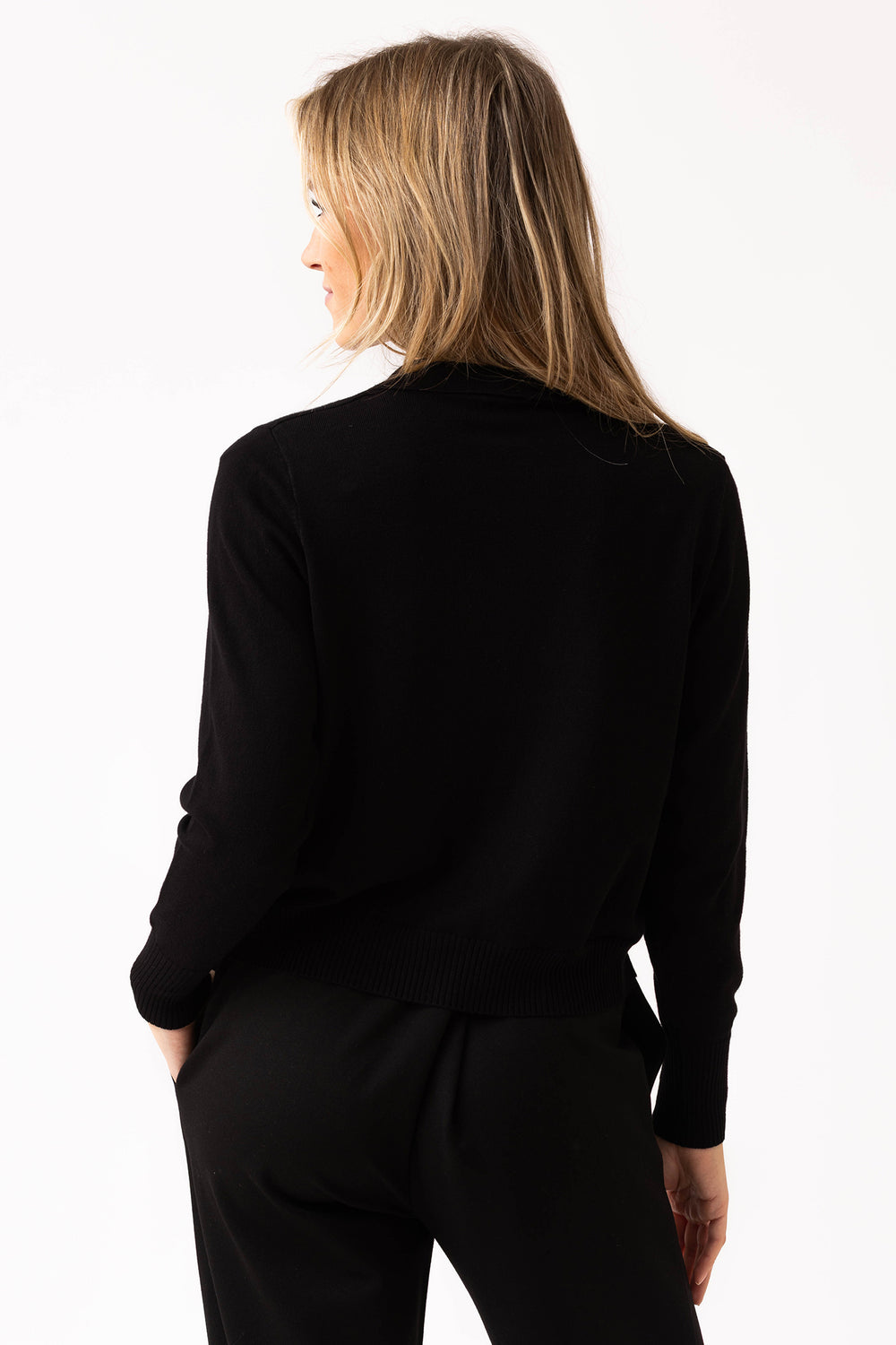 Person wearing a black outfit on a white background