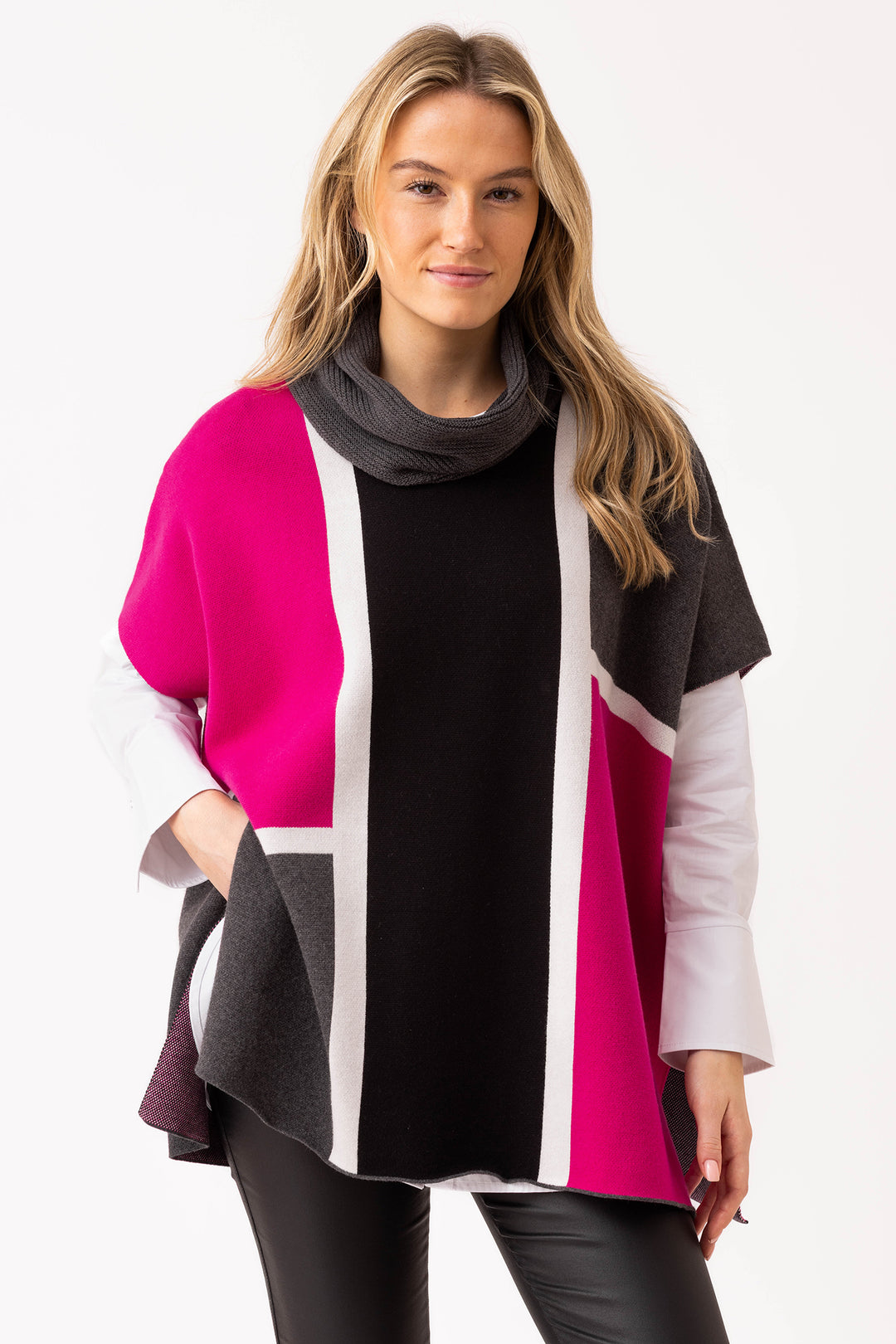 Woman wearing a colorful poncho with a white background