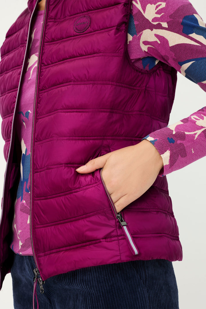 Close-up of a person wearing a purple puffer jacket with floral patterned lining.