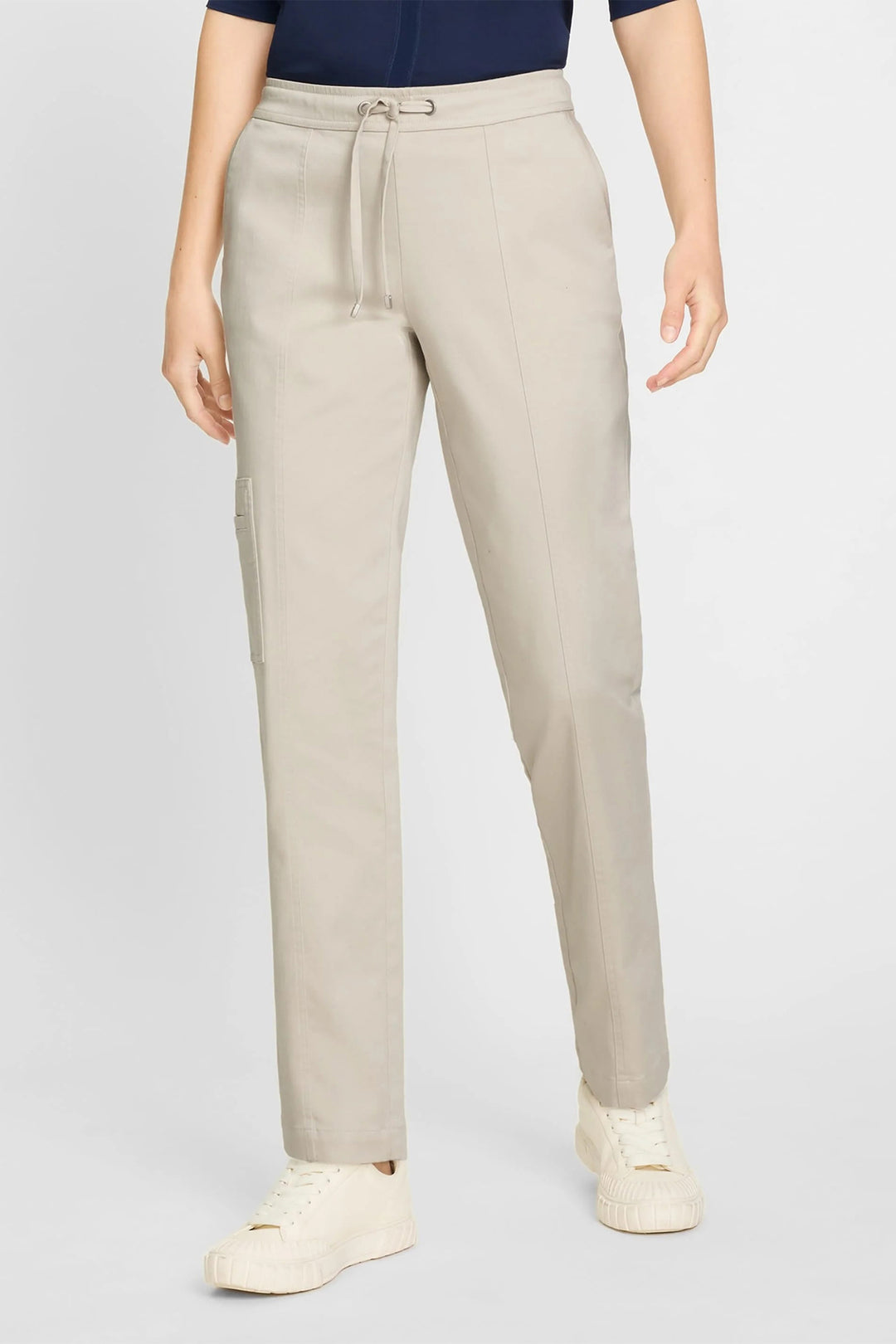 Person wearing beige pants on a light gray background