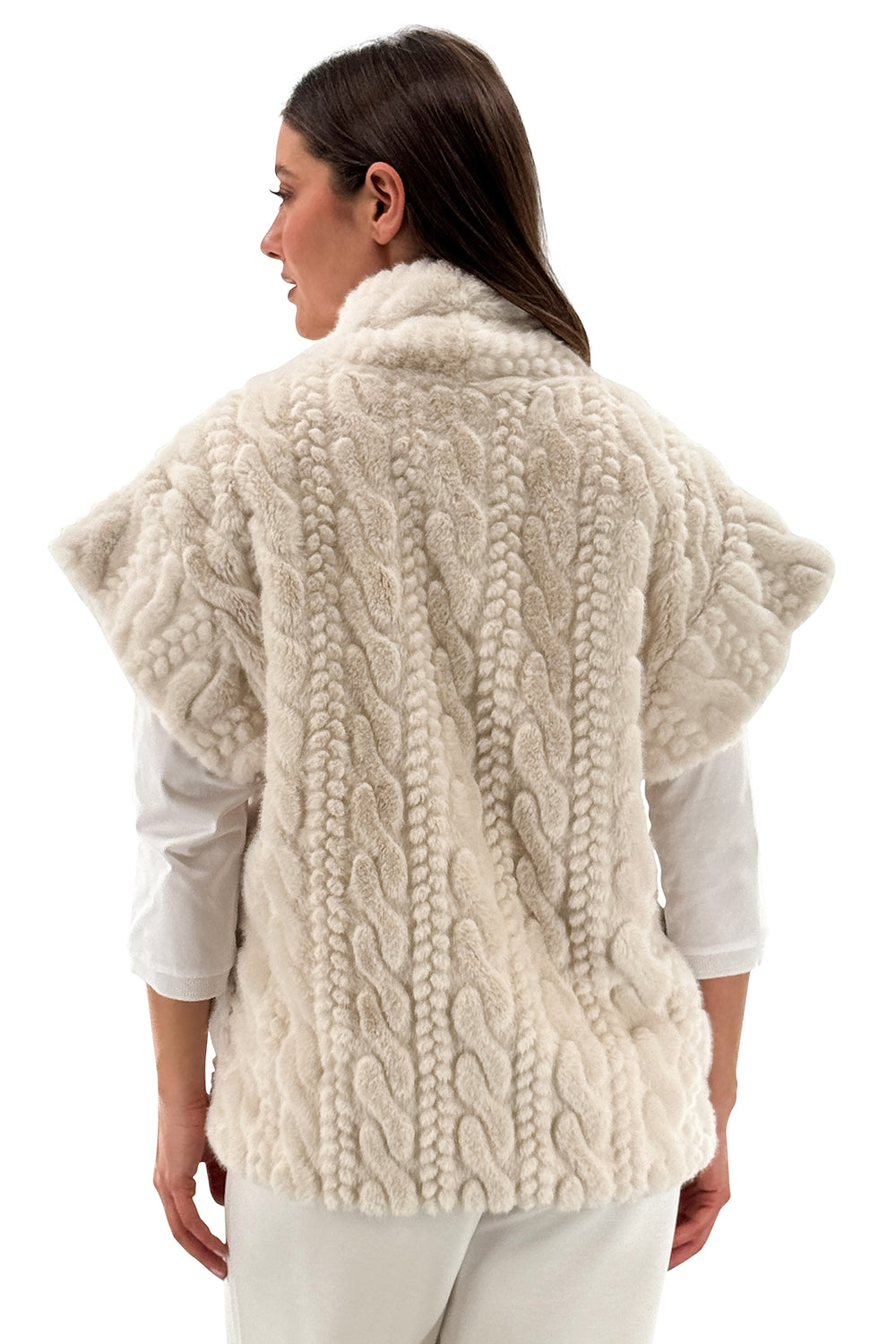 Woman wearing a cream-colored knitted vest on a white background