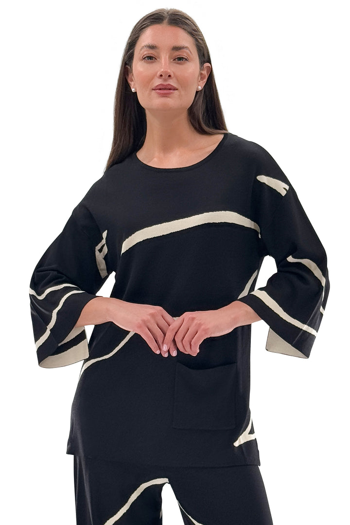 Woman wearing a black and white outfit with a white background