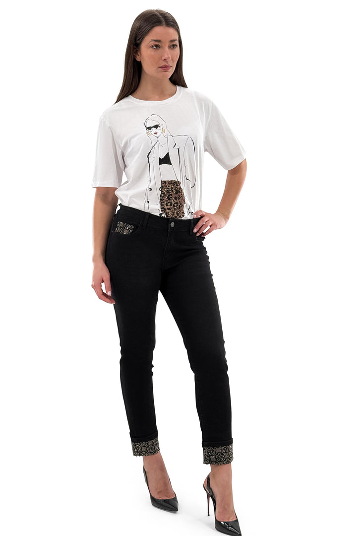 Woman wearing a white t-shirt with graphic design and black jeans on a white background