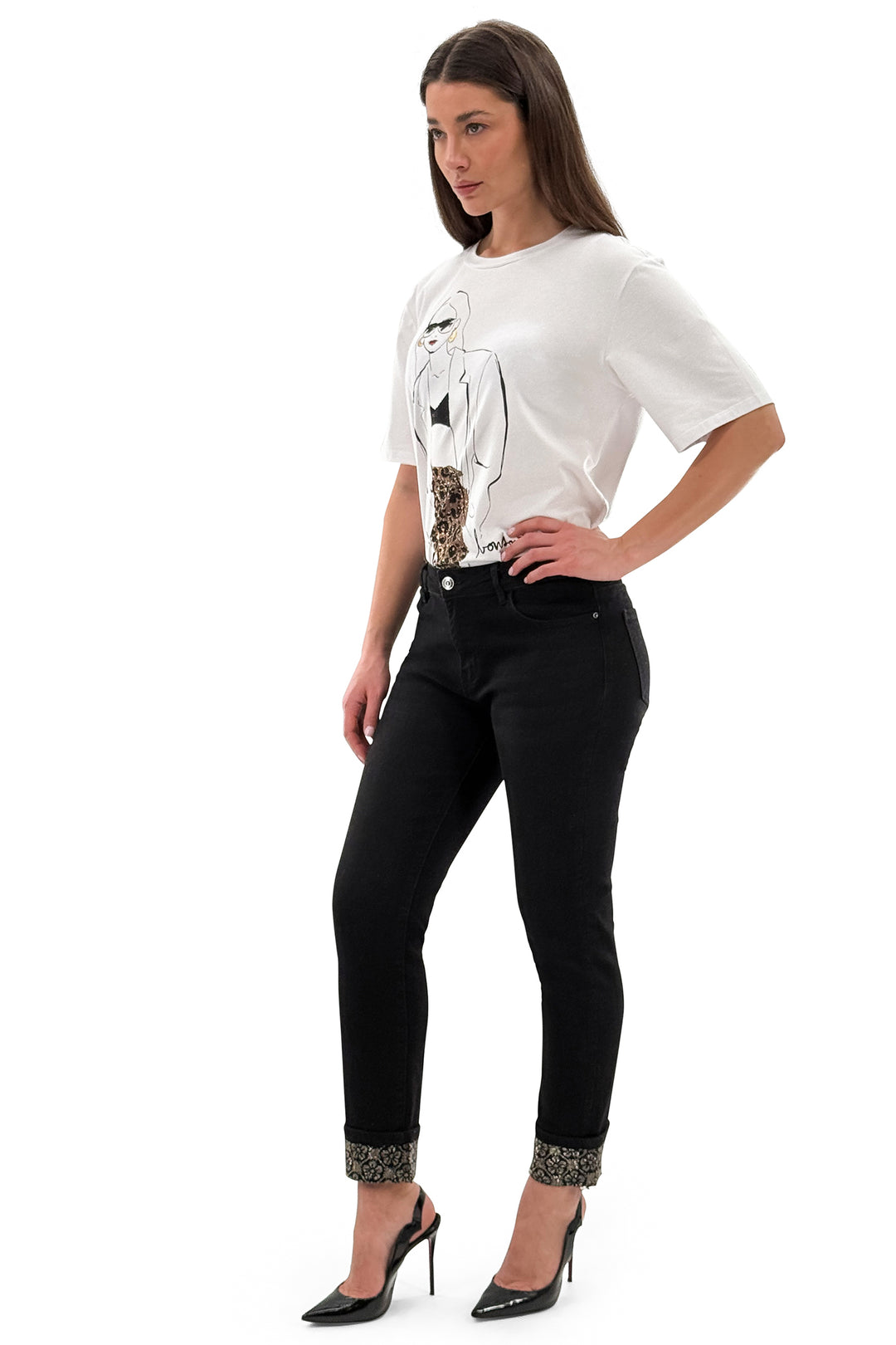 Woman wearing a white blouse with a graphic design and black pants on a white background