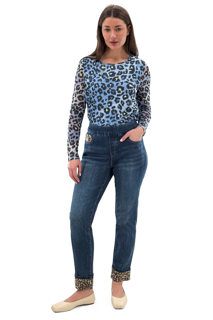 Woman wearing a blue leopard print top and jeans on a white background