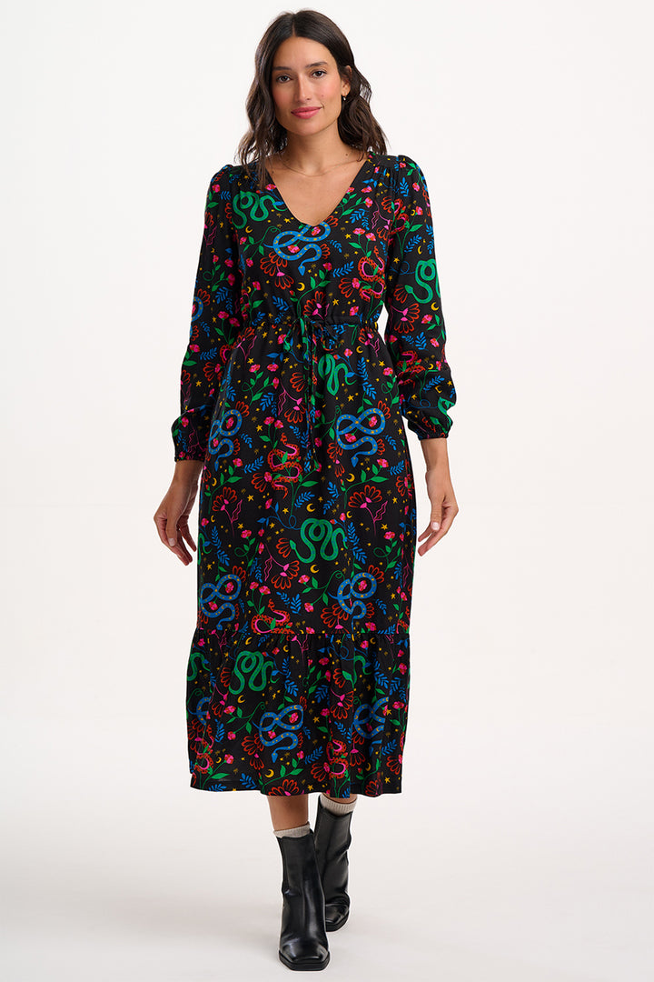 Woman wearing a colorful patterned dress on a white background