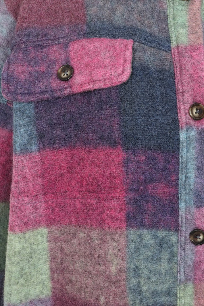 Close-up of a checkered fabric with pink, purple, and green colors.