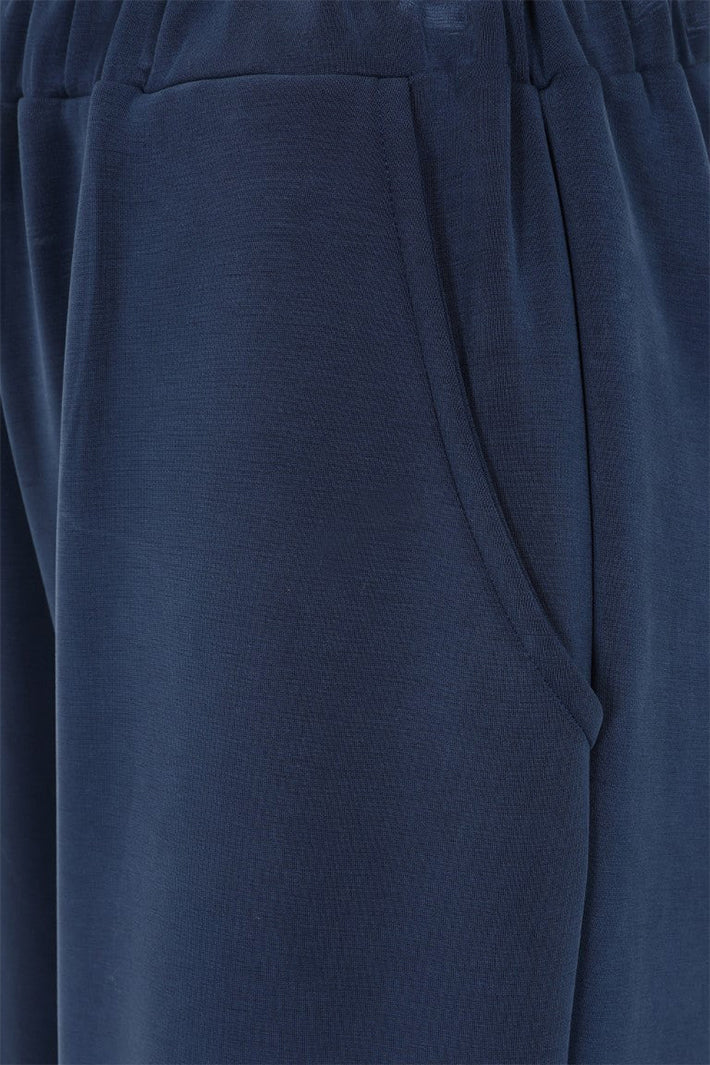 Close-up of a blue fabric with a pocket detail