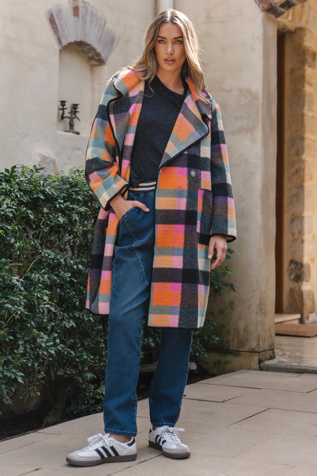 Person wearing a colorful plaid coat outdoors
