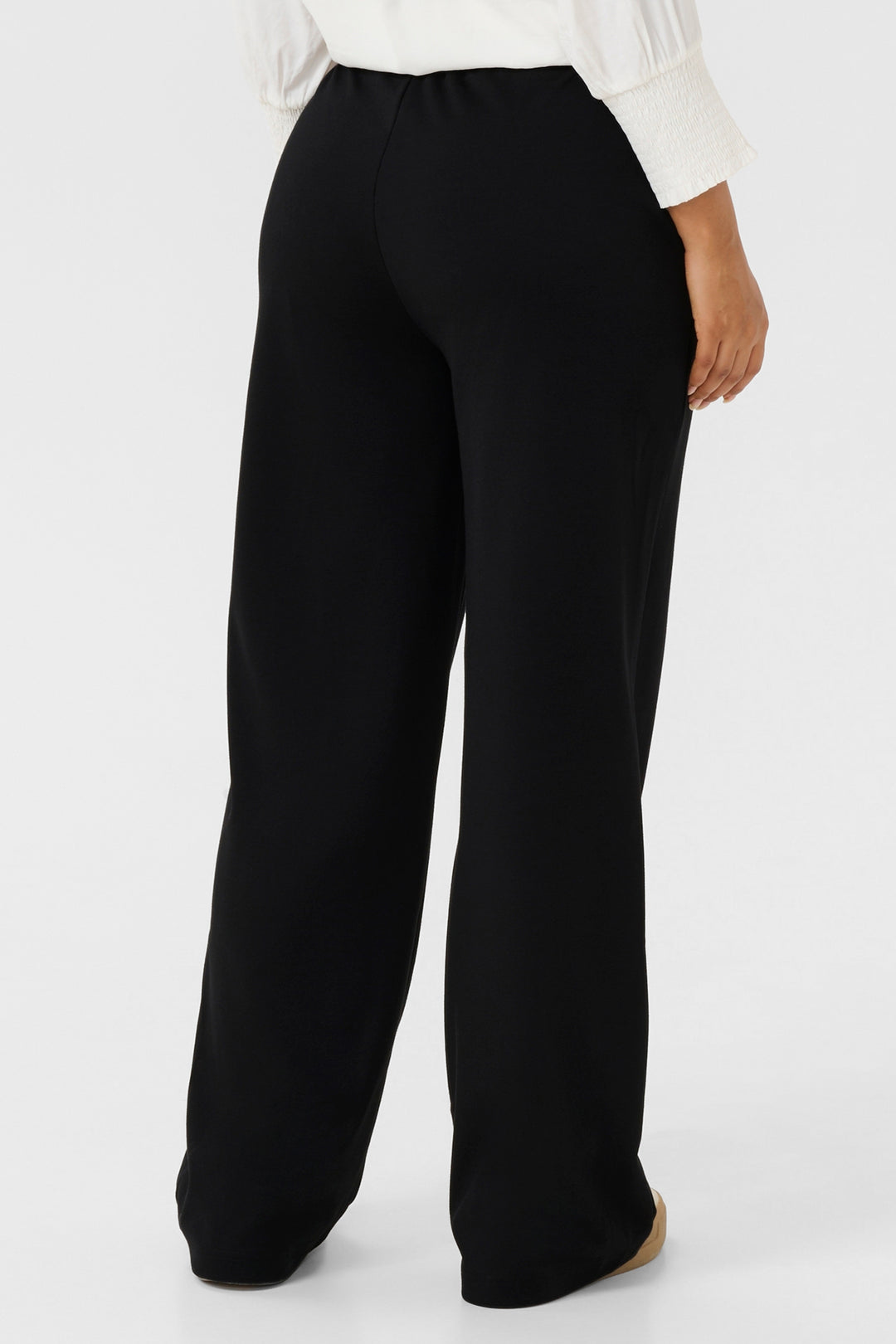 Black wide-leg pants worn by a person on a white background
