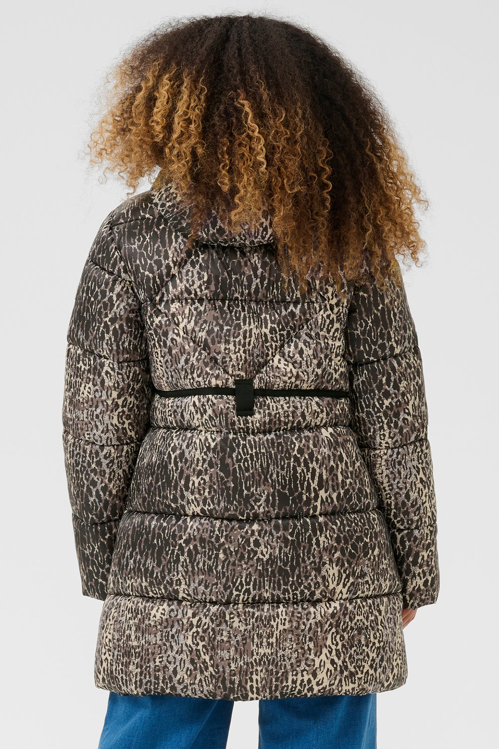 Person wearing a leopard print coat on a white background