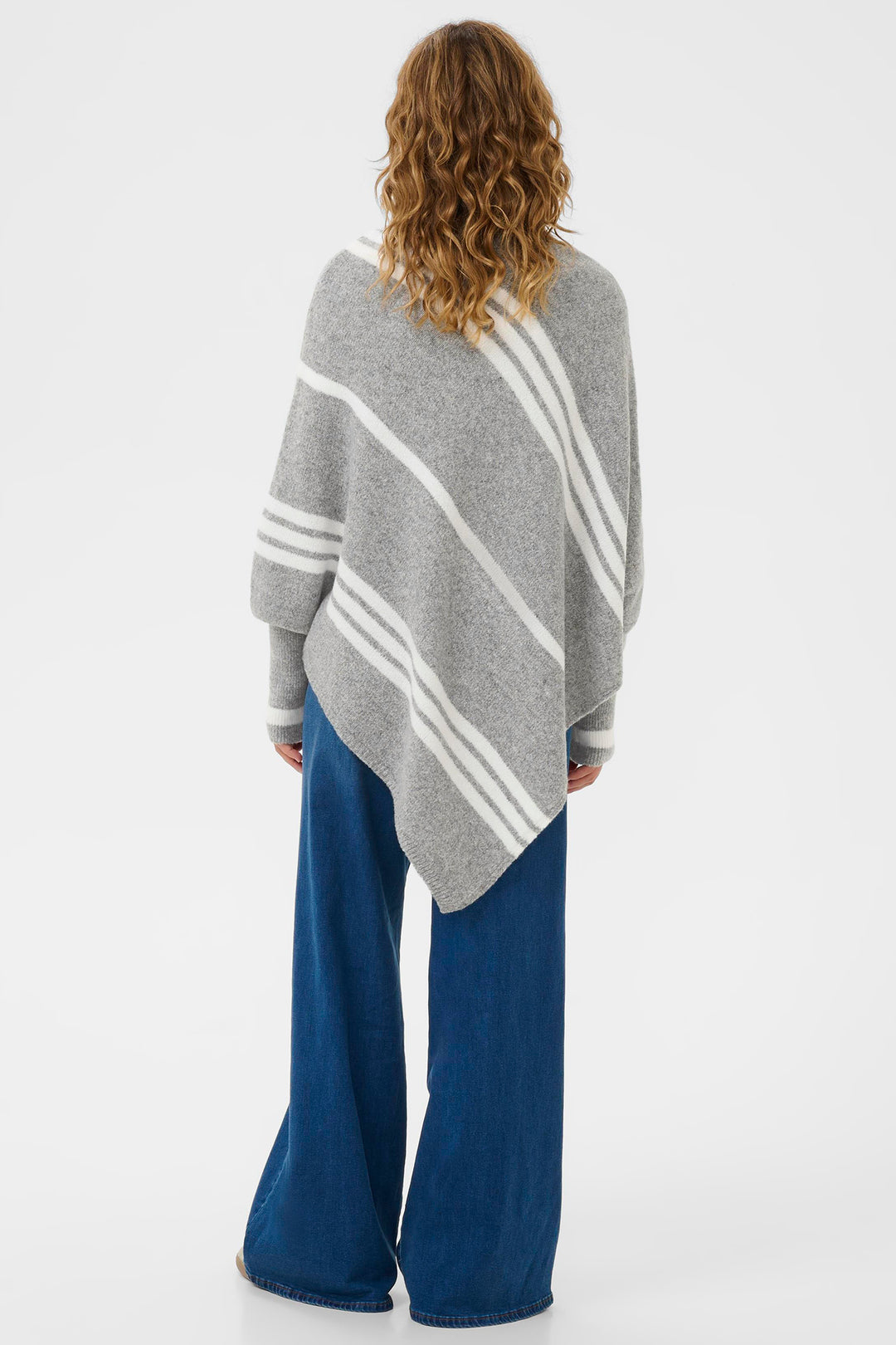 Person wearing a gray poncho with white stripes on a white background