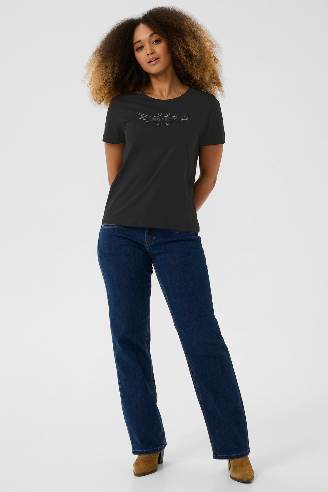 Woman wearing a black t-shirt and blue jeans on a white background