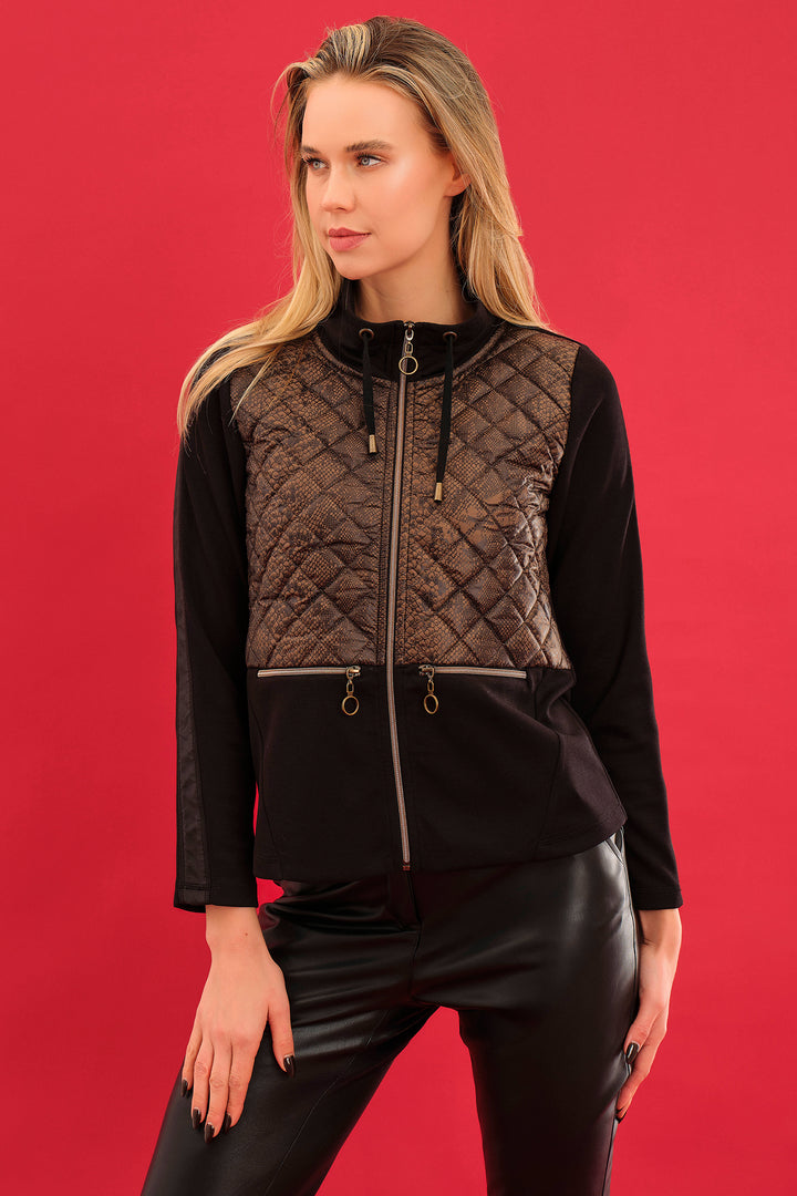 Woman wearing a black and brown quilted jacket against a red background