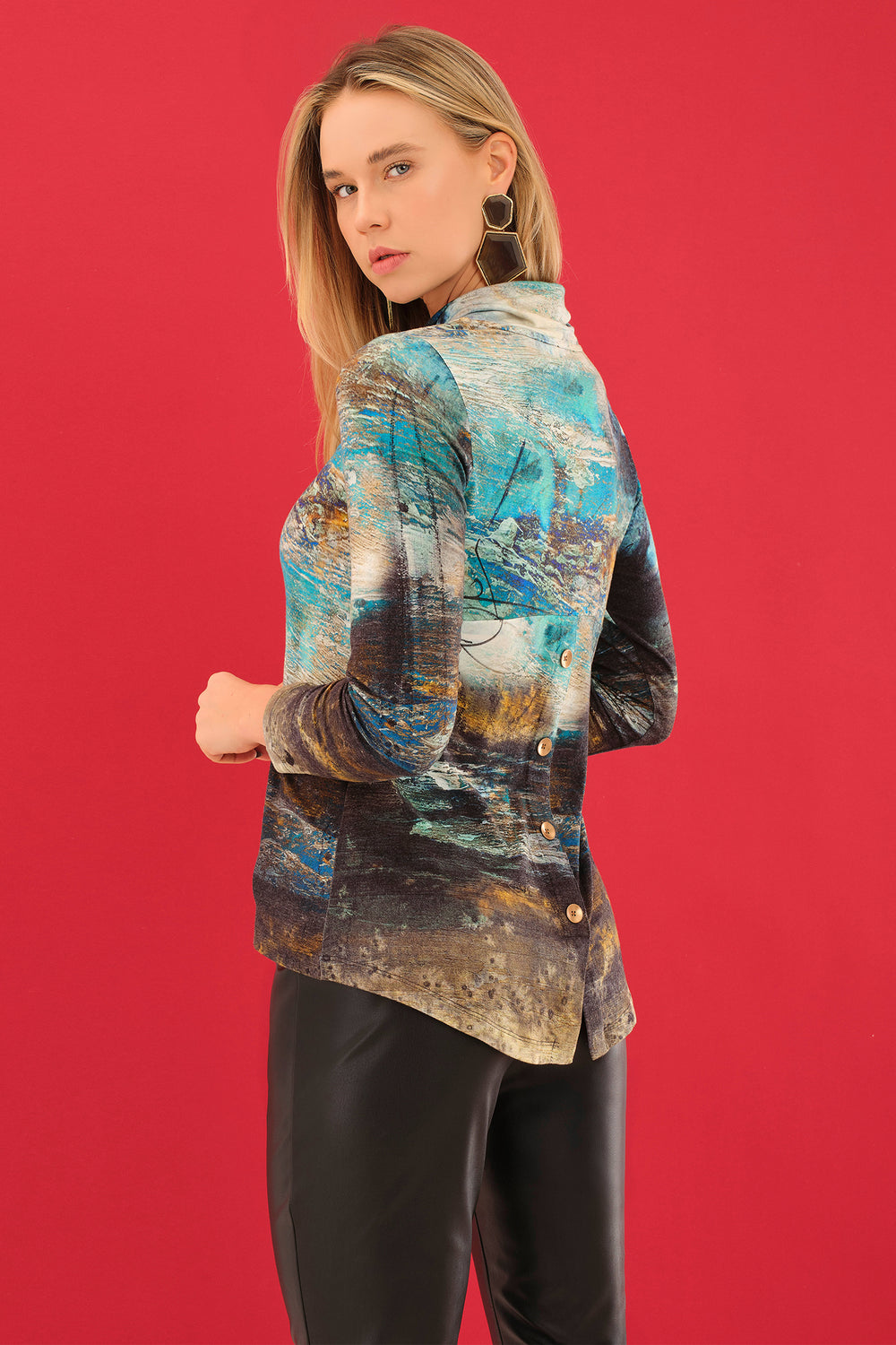 Woman wearing a colorful jacket against a red background