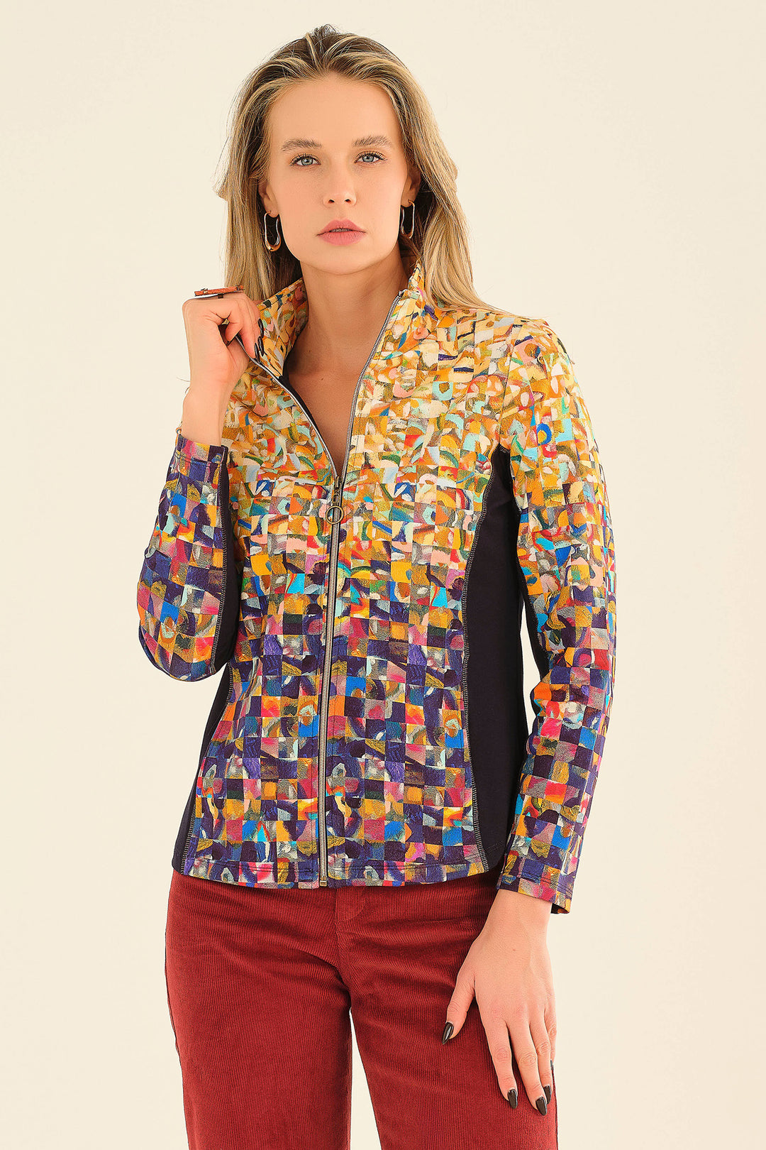 Woman wearing a colorful patterned jacket on a beige background