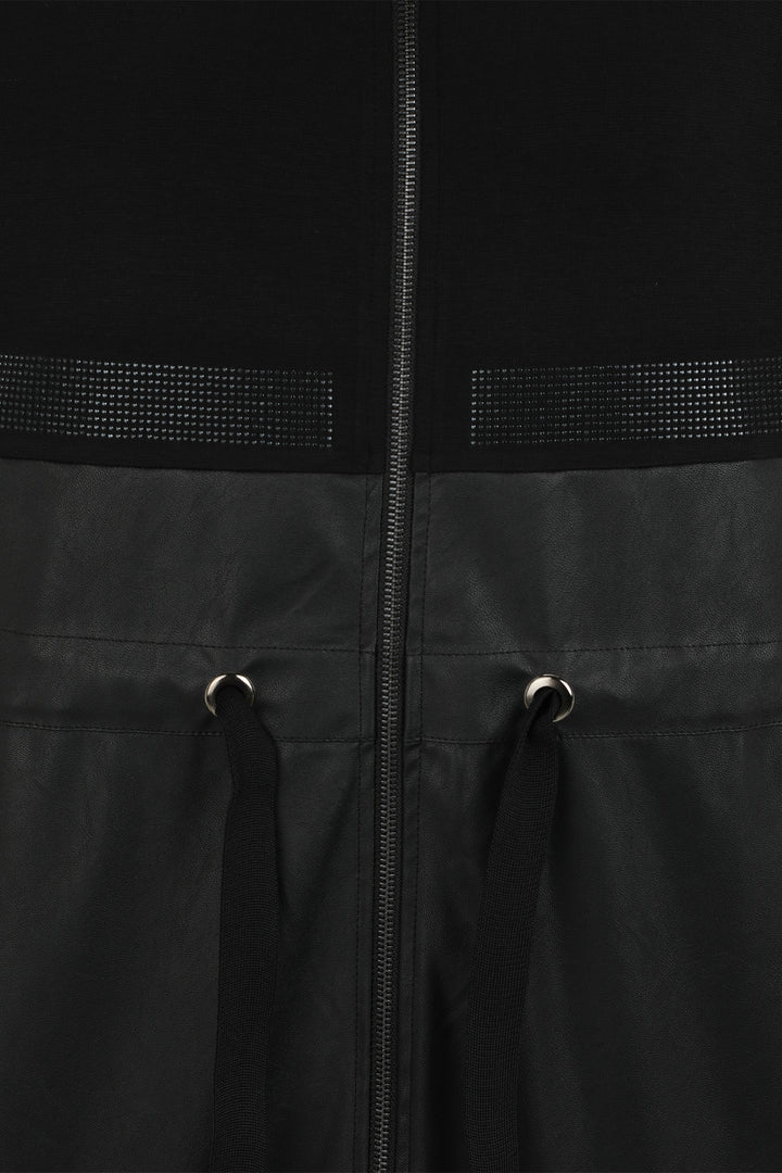 Close-up of a black jacket with a zipper and textured panels.