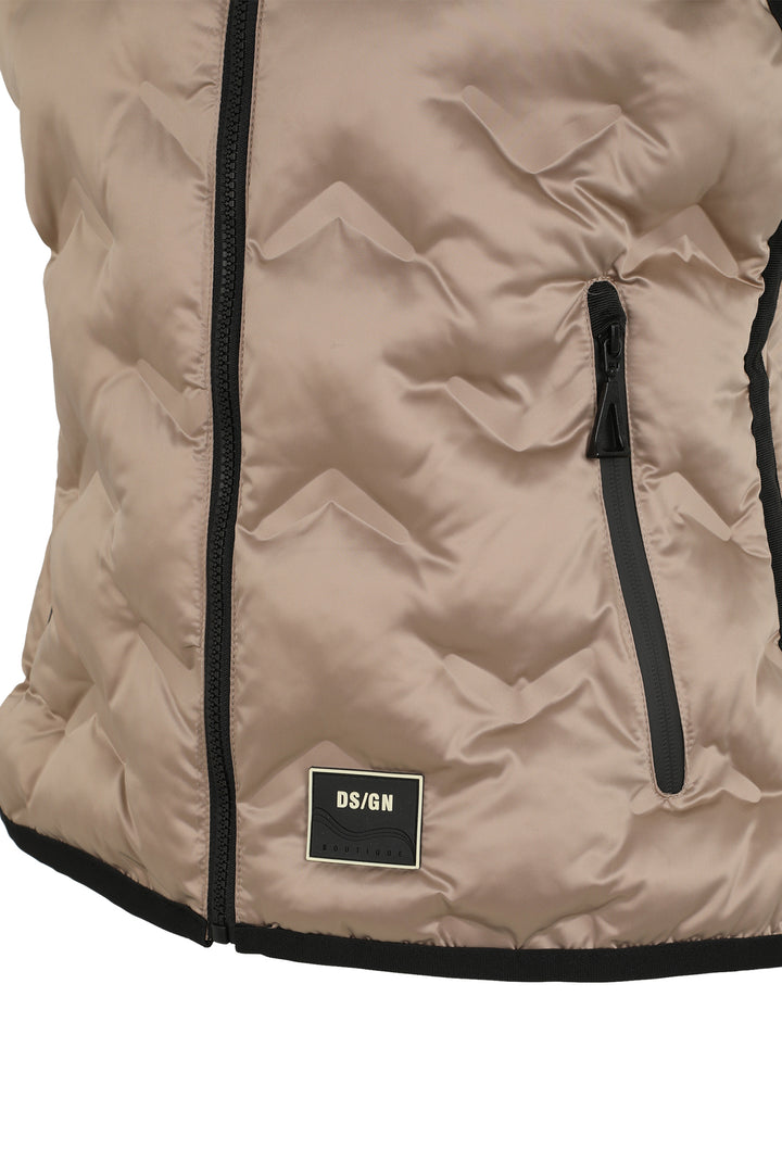 Close-up of a beige quilted vest with black zipper and DS/GN label on a white background
