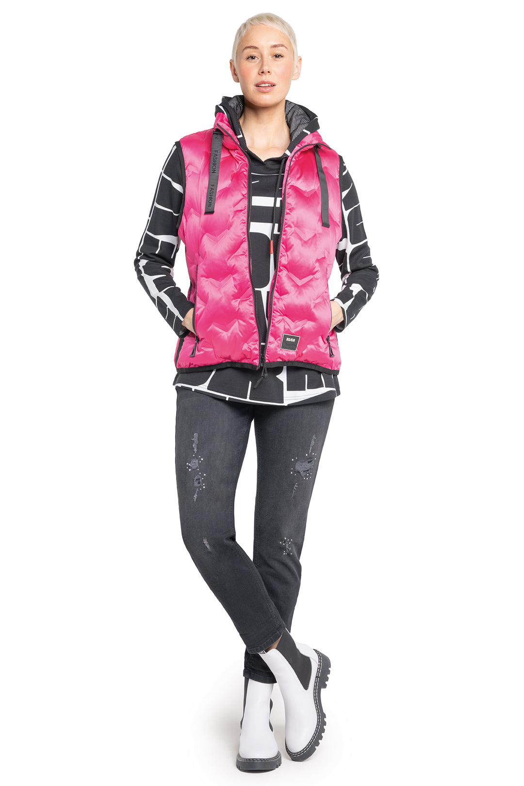 Person wearing a pink and black jacket with a white background
