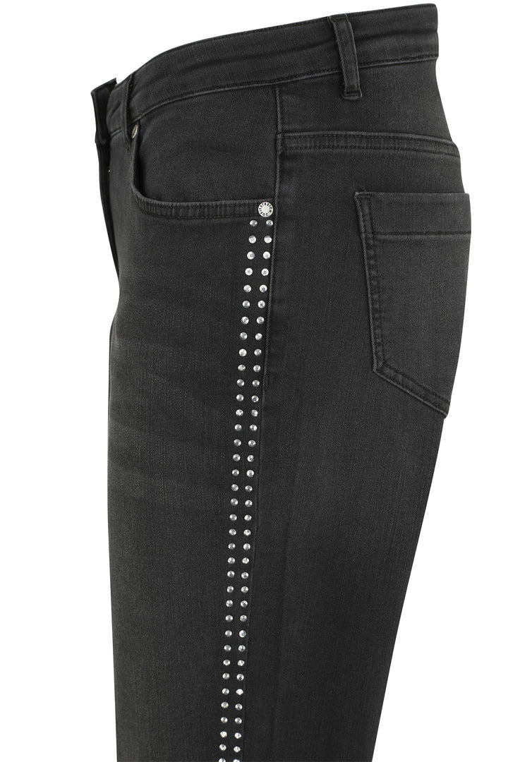 Black jeans with studded details on a white background