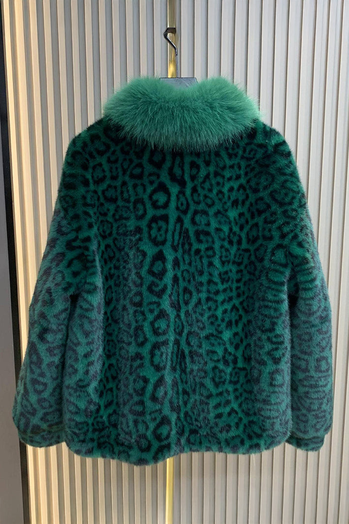Green leopard print coat on a hanger against a striped background