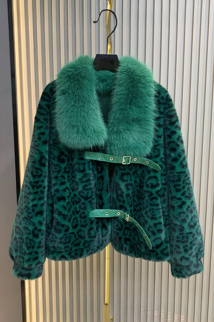 Green leopard print coat with fur collar on a hanger against a neutral background