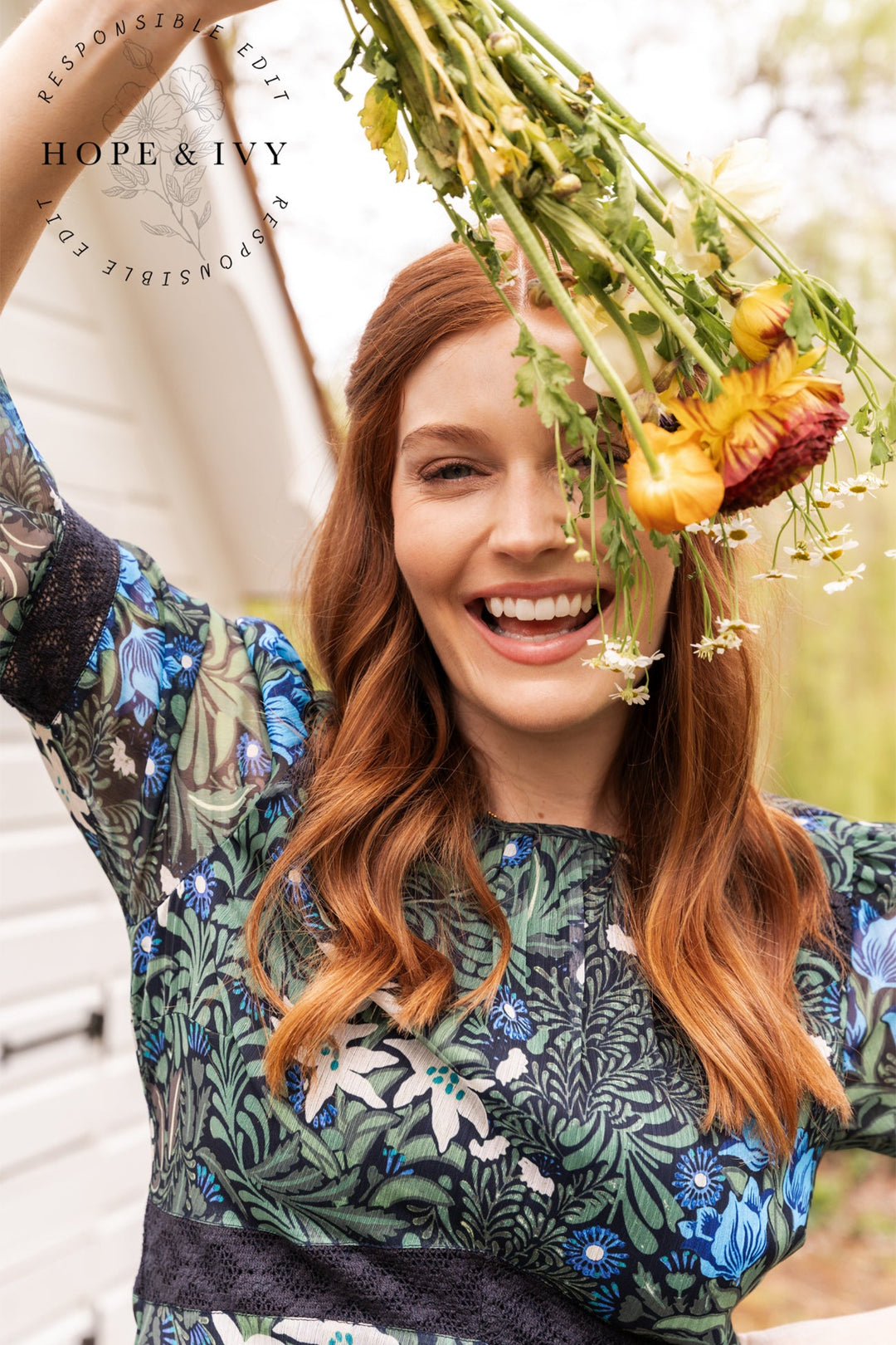 Woman holding a bouquet of flowers with 'Hope & Ivy' branding in the background.