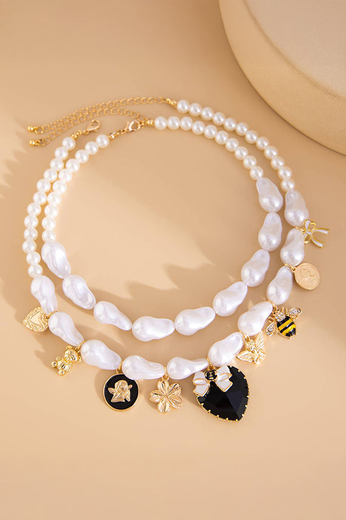 Pearl necklace with decorative charms on a beige background