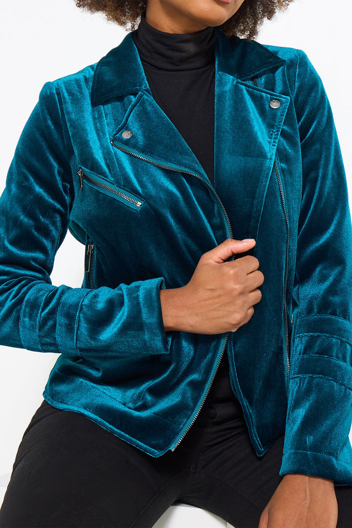 Person wearing a blue velvet jacket on a white background