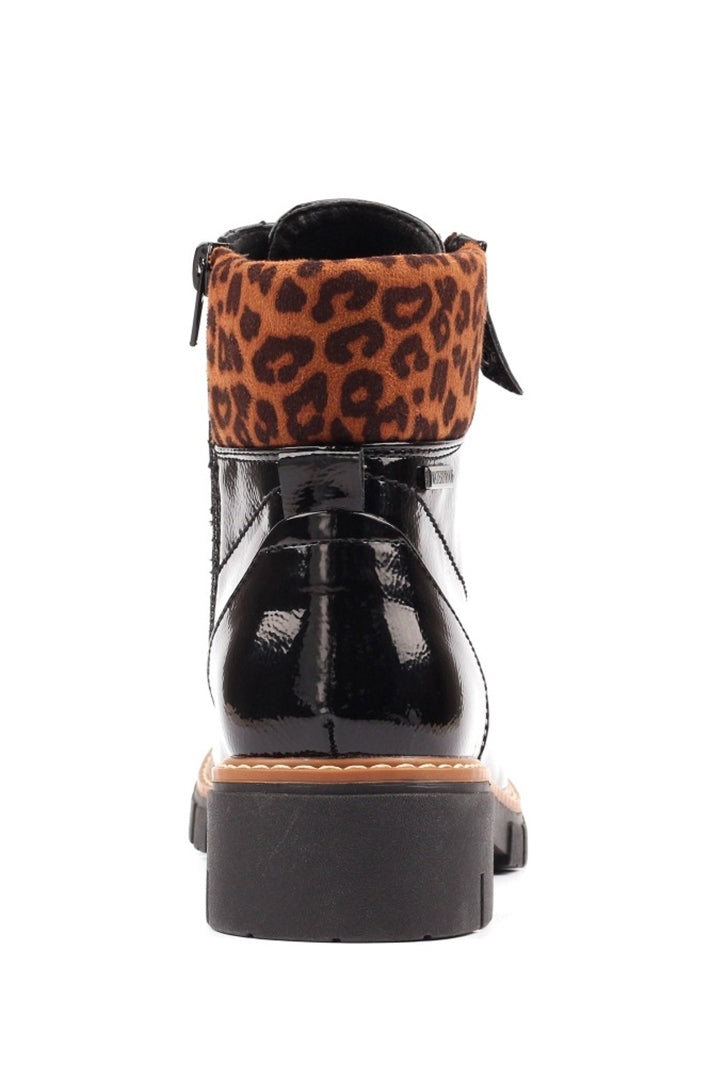 Black boot with a leopard print strap on a white background