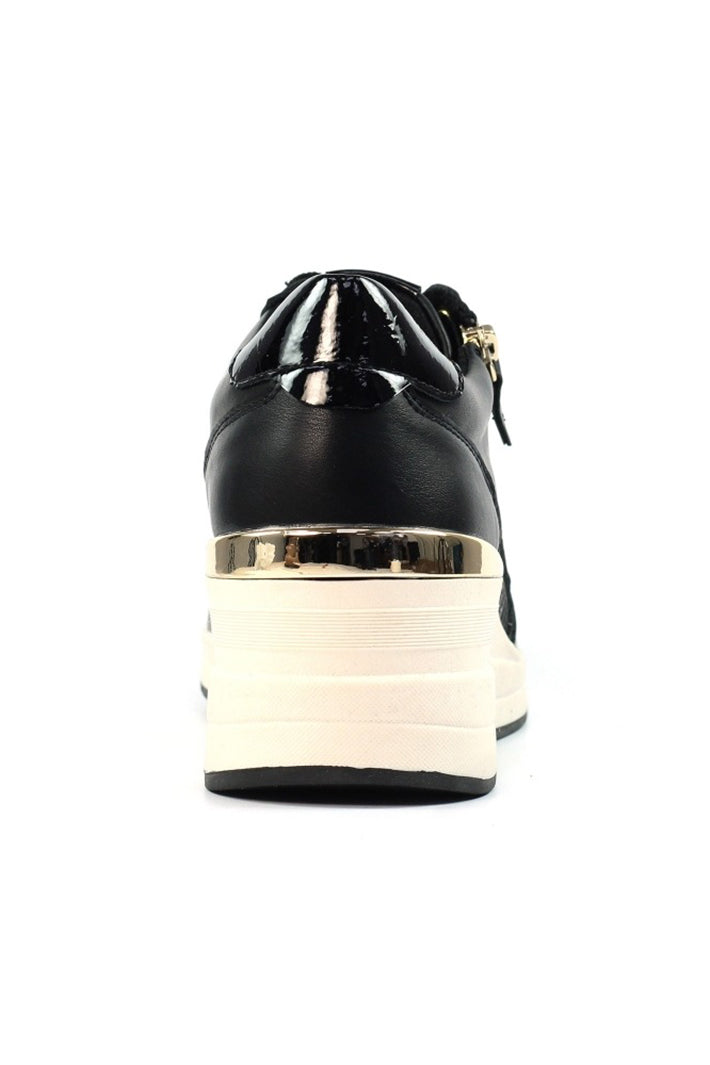 Black and white shoe with gold accents on a white background