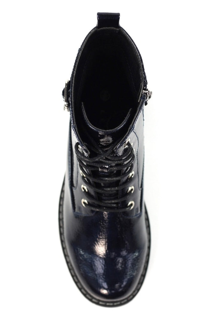 Navy leather boot with metal eyelets on a white background