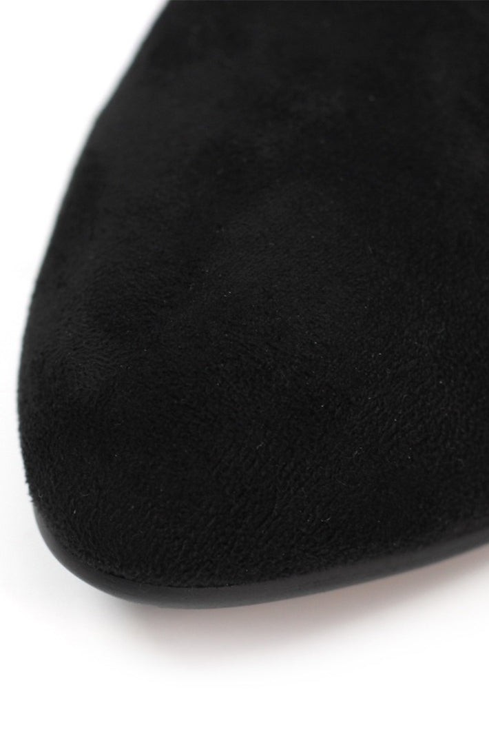 Close-up of a black sock on a white background