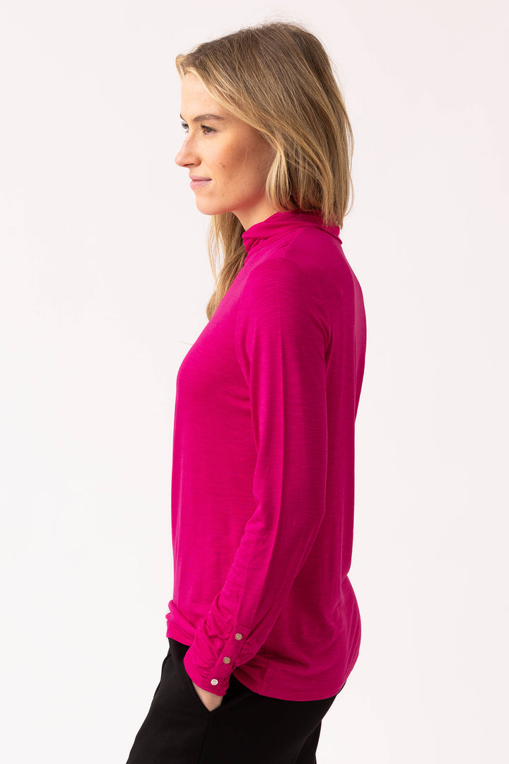 Woman wearing a bright pink blouse on a white background