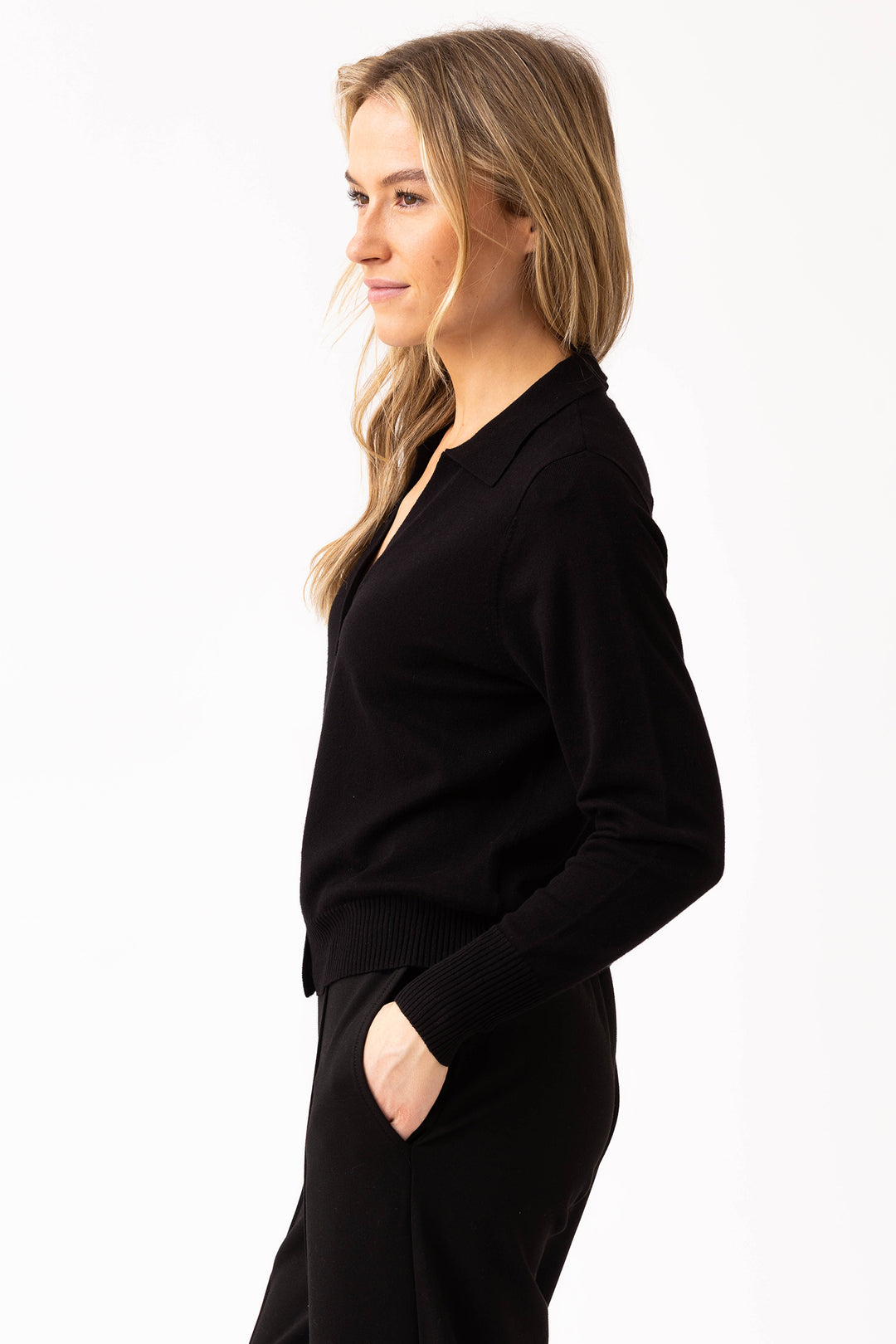 Woman wearing a black cardigan on a white background