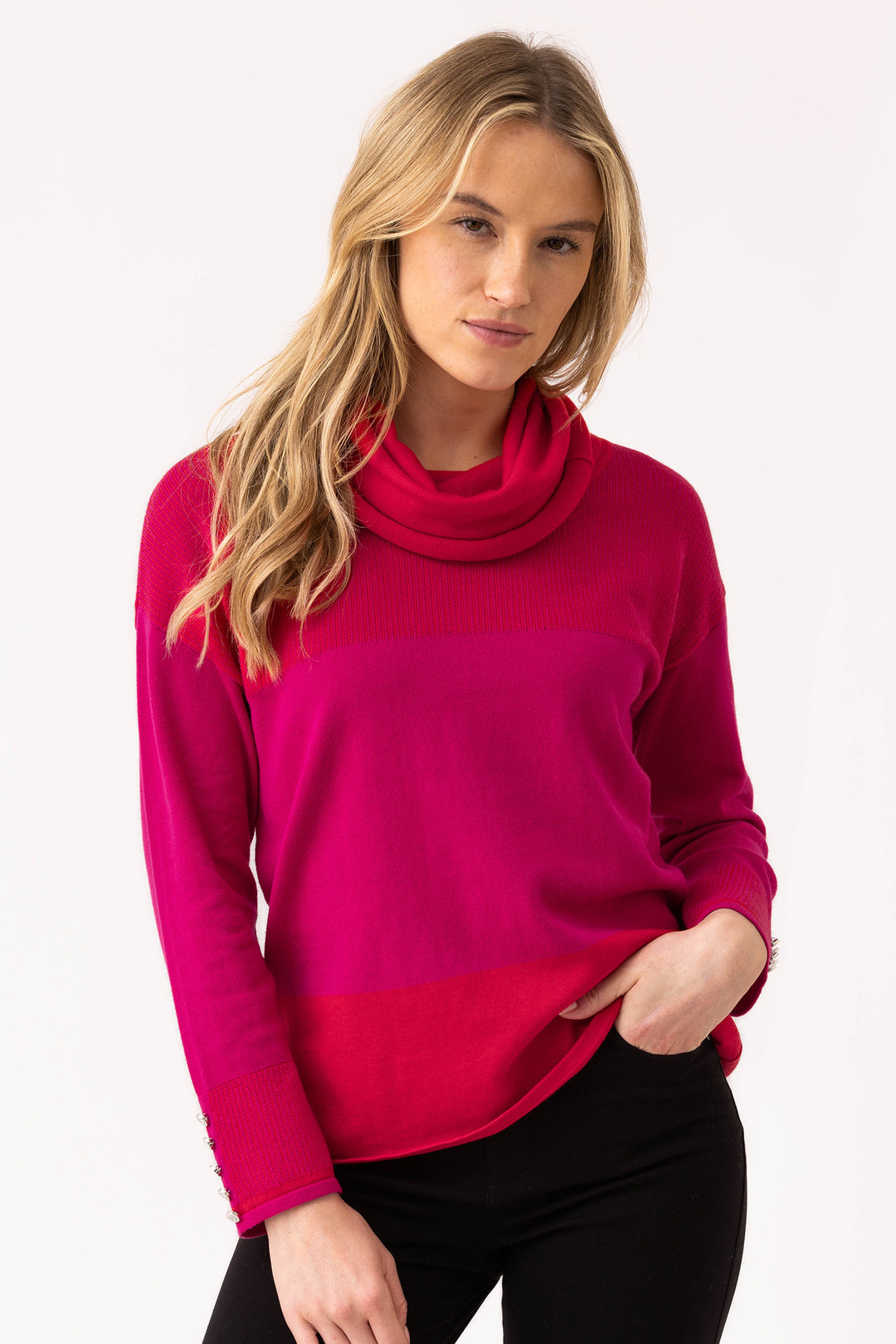 Woman wearing a bright pink sweater on a white background