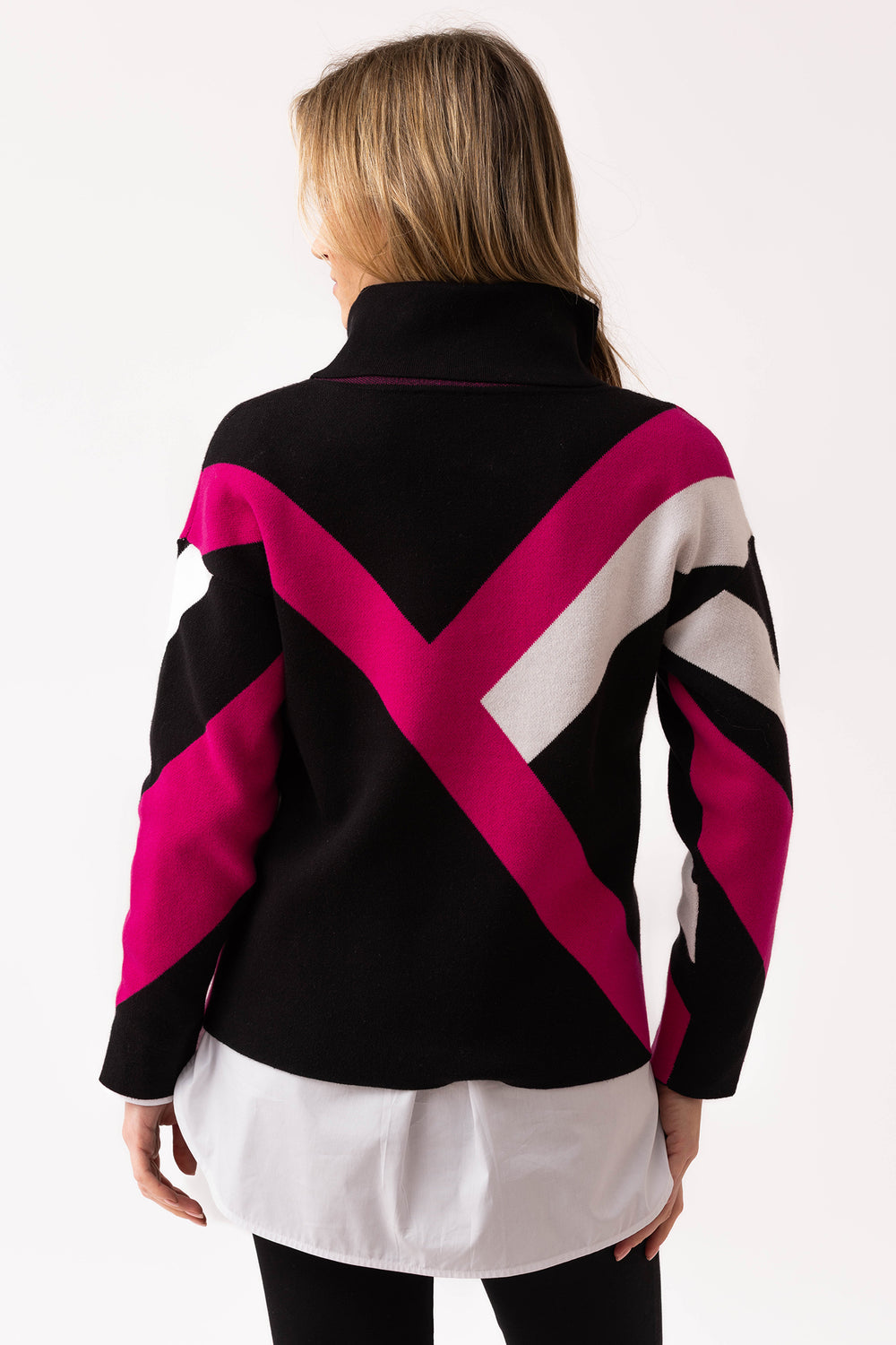 Person wearing a black, pink, and white patterned jacket on a white background