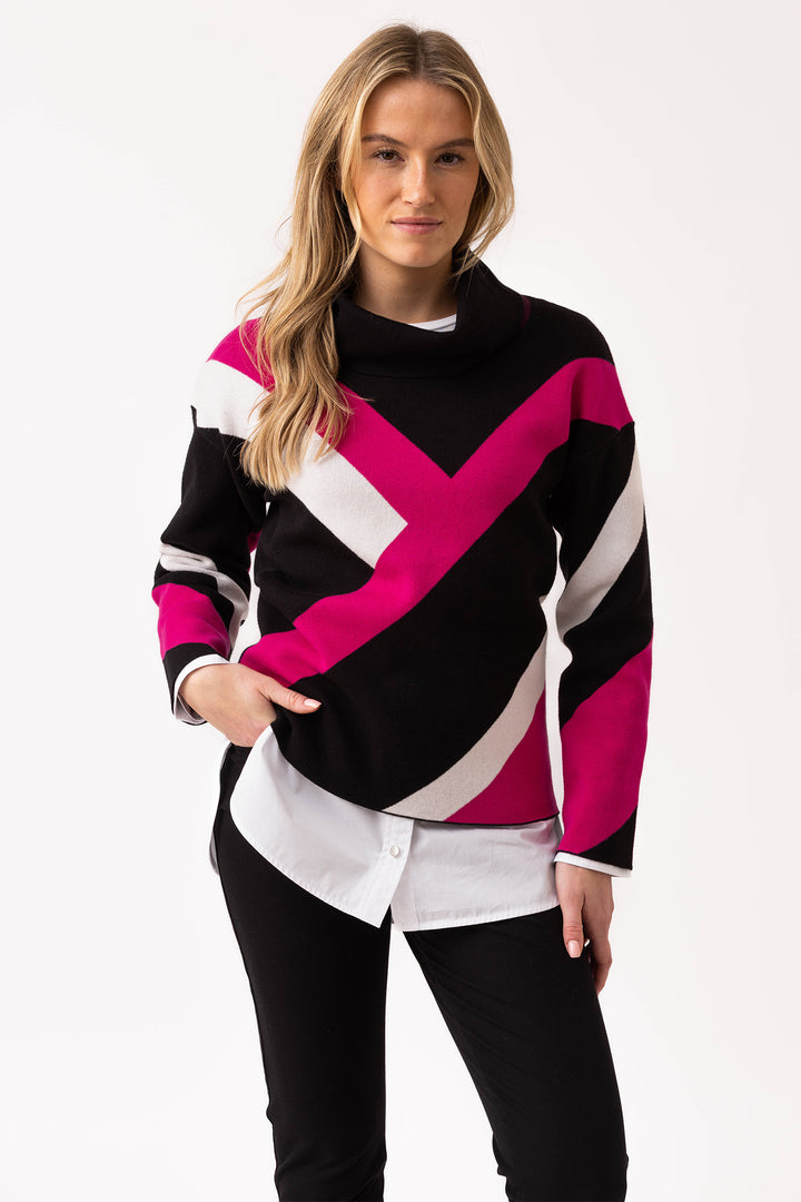 Woman wearing a colorful sweater with a white background