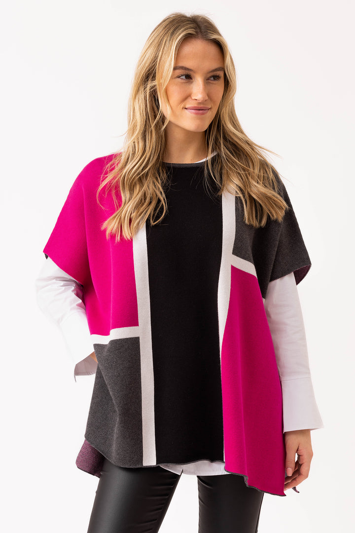 Woman wearing a colorful cardigan with a white background