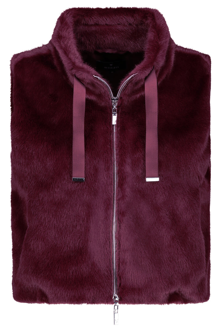 Folded burgundy fur vest on a white background