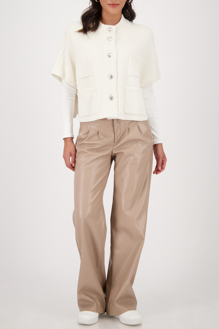 Person wearing a white blouse and beige pants on a white background