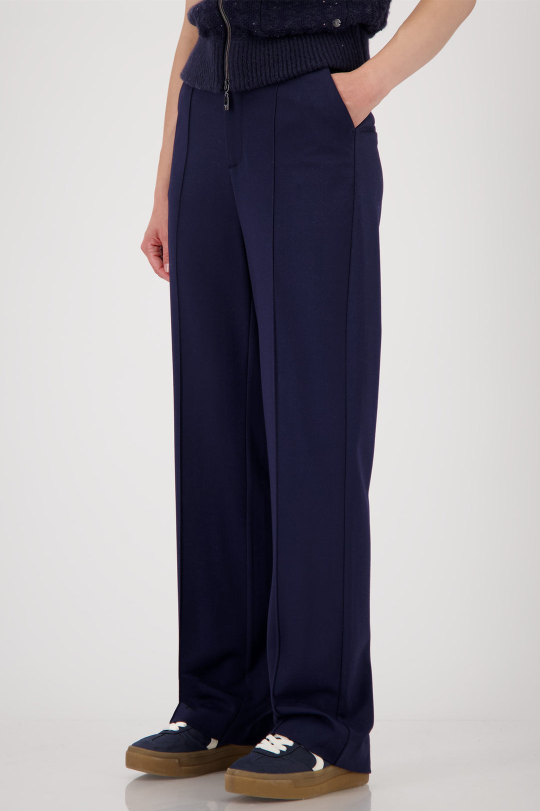 Navy blue wide-leg pants worn by a person on a white background