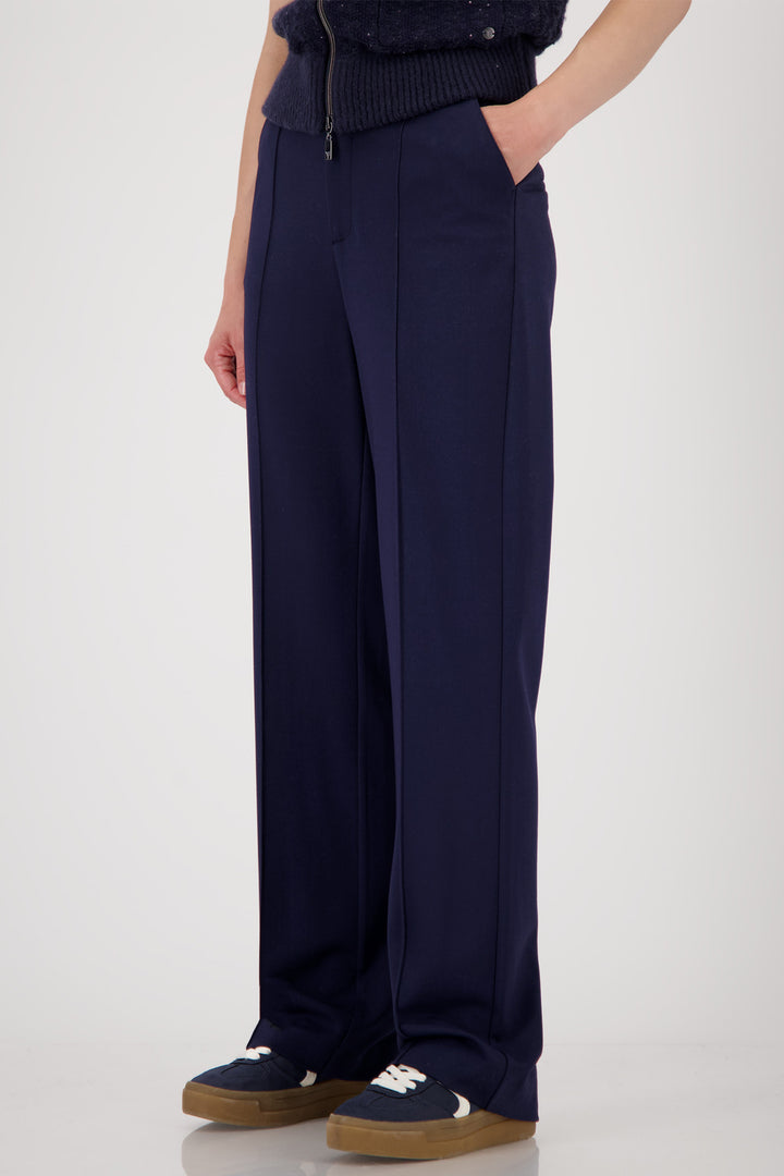 Navy blue wide-leg pants worn by a person on a white background