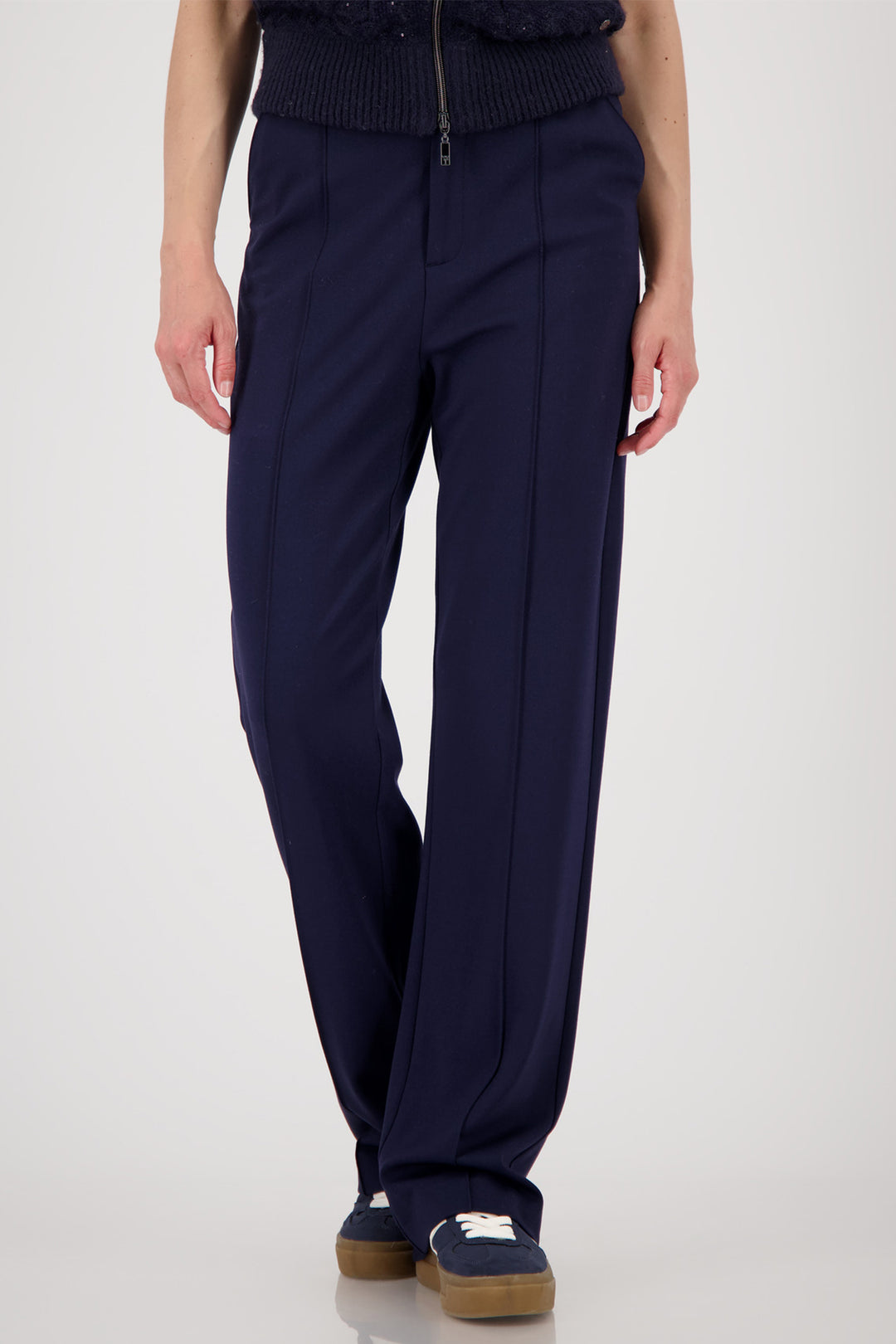 Navy blue pants worn by a person on a white background